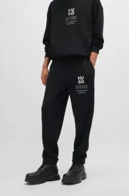 Relaxed-fit tracksuit bottoms with logo and slogans