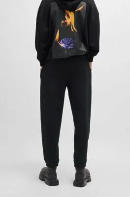 Relaxed-fit tracksuit bottoms with logo and slogans