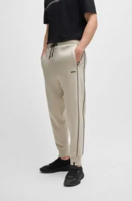 Stretch-cotton tracksuit bottoms with embossed artwork